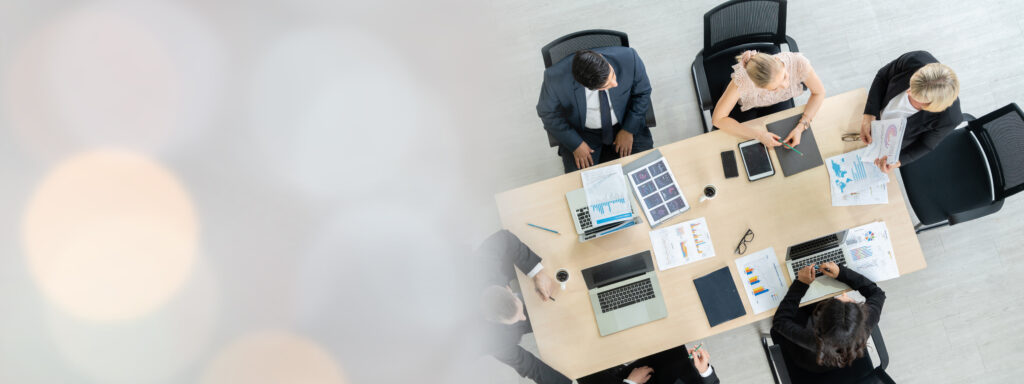 Business people group meeting shot from top widen view in office . Profession businesswomen, businessmen and office workers working in team conference with project planning document on meeting table .